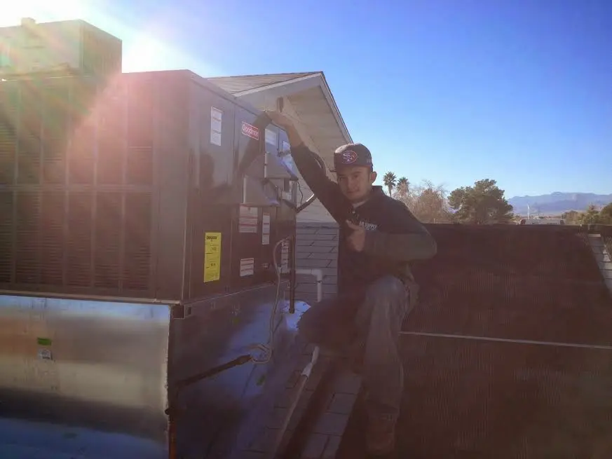 HVAC technician performing HVAC Inspection on a rooftop unit in Rocklin